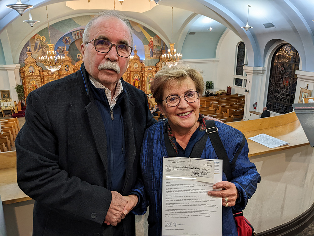 [L-R] Emil Yereniuk (SJLF President) and Julia Elaschuk (UWAC St John's Branch President) accepting SJLF's donation for the "Ukrainian Writers Mosaic Portraits" Project